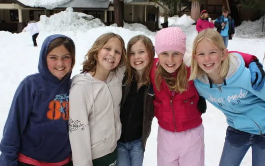 a group of people posing for a photo in the snow
