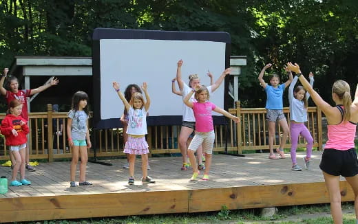 a group of children playing on a wooden deck