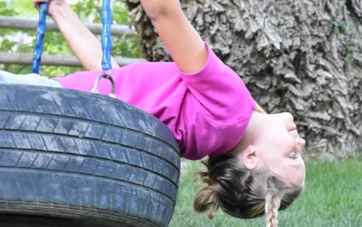 a girl lying on a bench