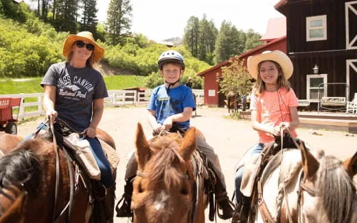 a group of people ride horses