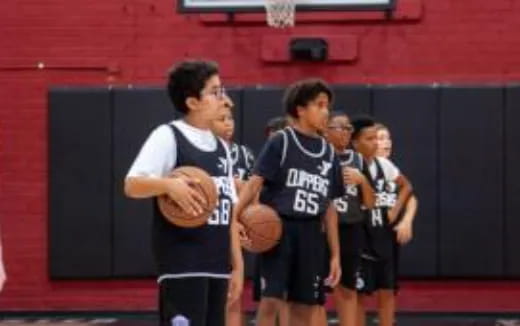 a group of boys playing basketball