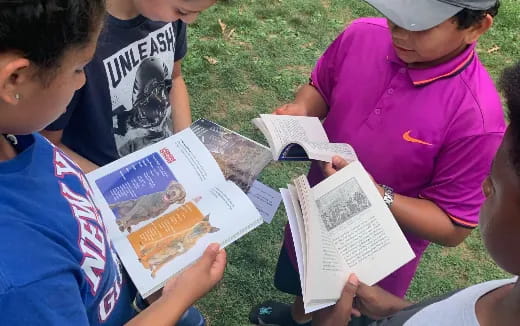 a group of people reading books