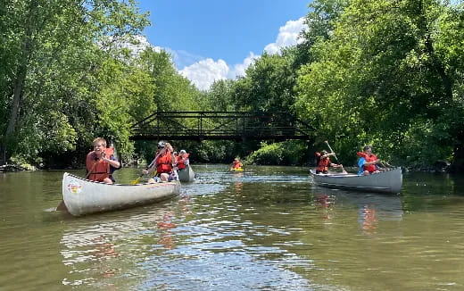 a group of people in boats on a river