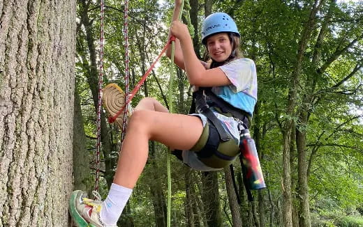 a woman climbing a tree