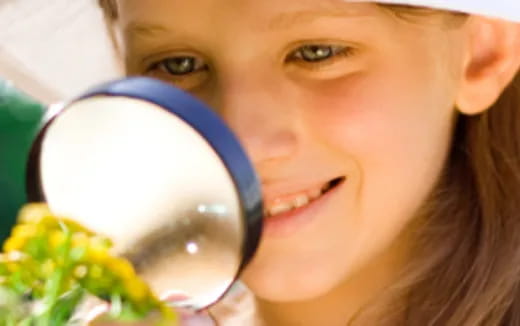 a girl wearing a magnifying glass