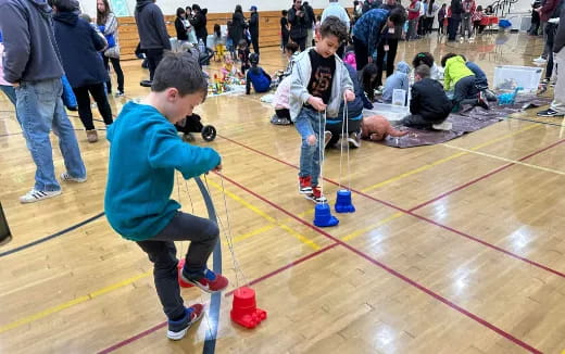 a boy filming a boy with a camera