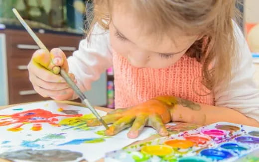 a girl painting with a brush