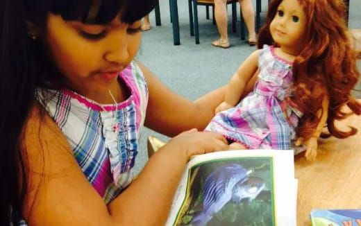 a girl holding a book