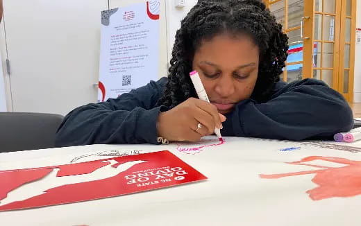 a person writing on a piece of paper