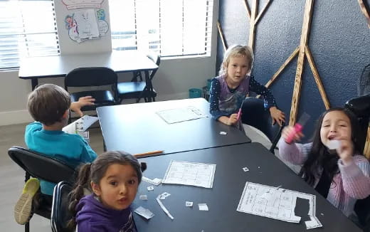 a group of children sitting at a table