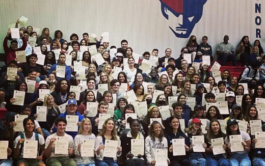 a group of people holding papers