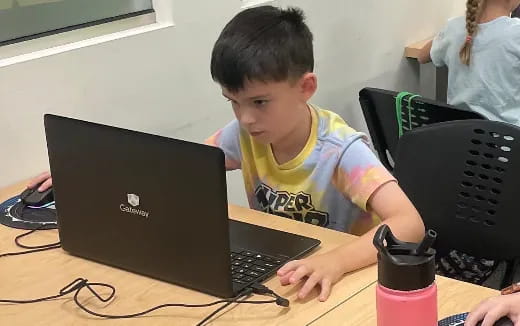 a boy using a laptop