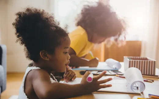 a young girl and a young boy studying