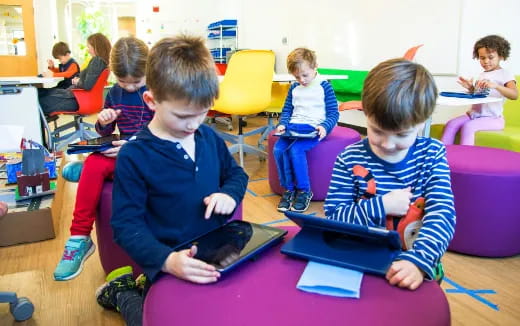 a group of children sitting in a classroom