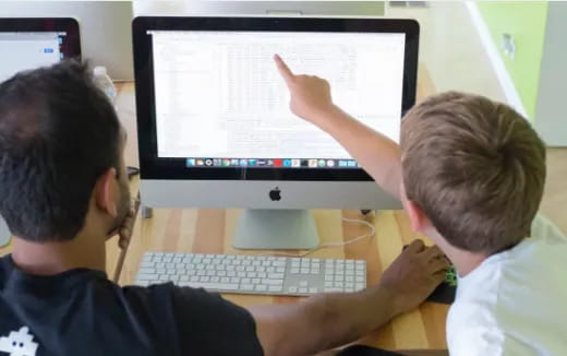 a few men looking at a computer screen