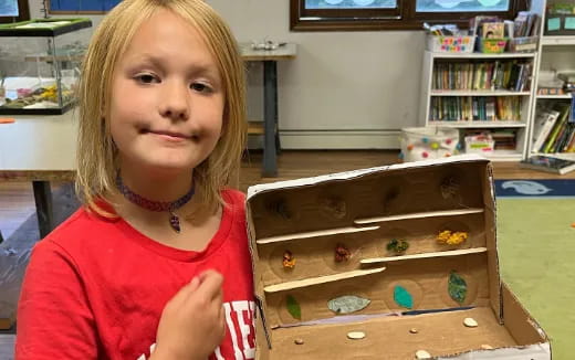 a girl holding a box