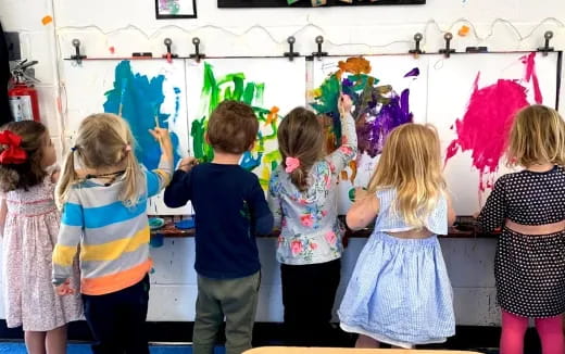 a group of children painting