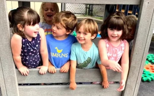 a group of children sitting on a bench