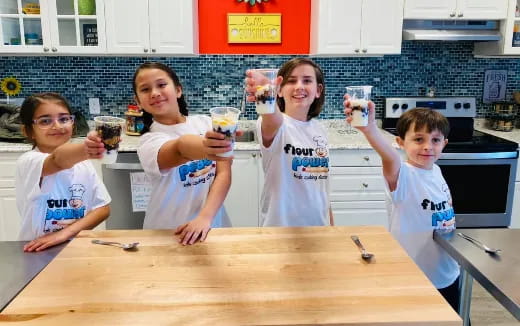 a group of kids holding cups