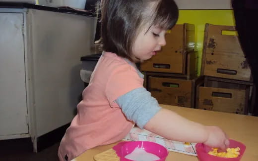 a girl sitting at a table