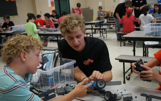 a few young boys working on a project