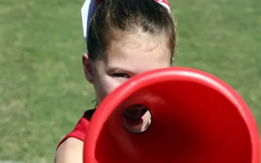 a child holding a red frisbee