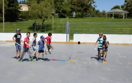 a group of kids playing on a skateboard