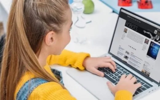 a young girl using a laptop