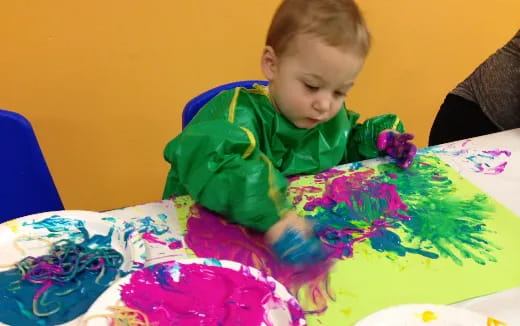 a child painting on a table
