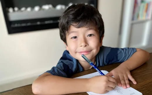 a boy holding a pen