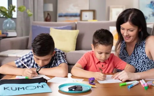 a person and a boy sitting at a table