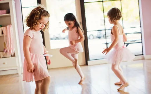 a group of girls in dresses running