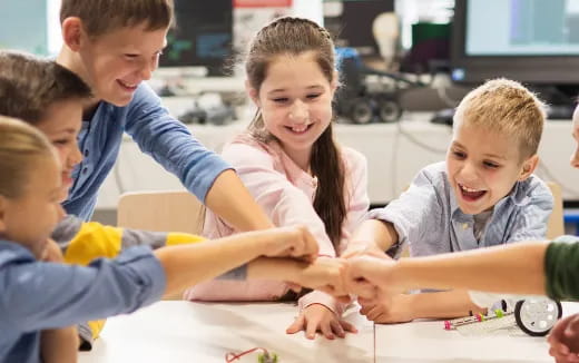 a group of children sitting at a table