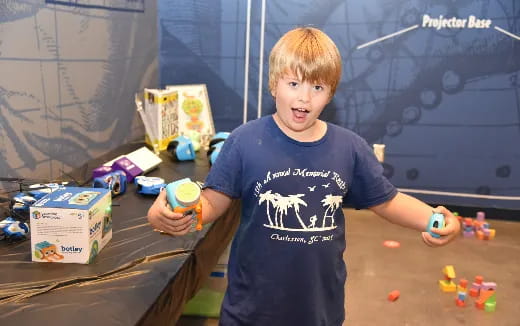 a boy holding a toy