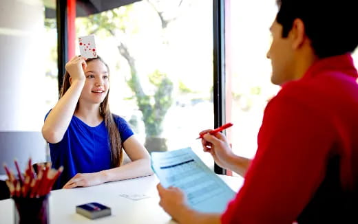 a man and a woman looking at a paper