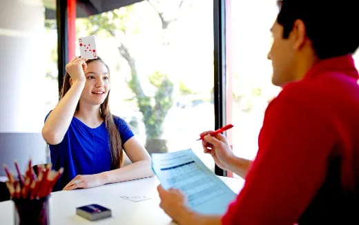 a man and a woman looking at a paper
