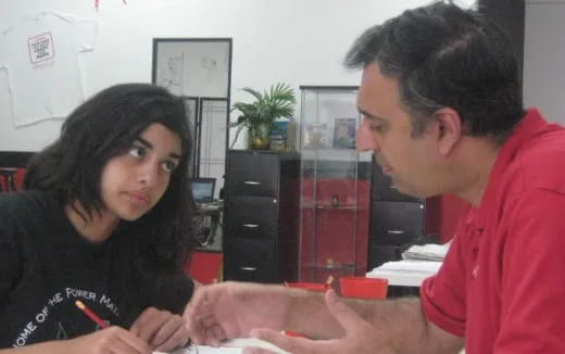 a man and a woman looking at a paper