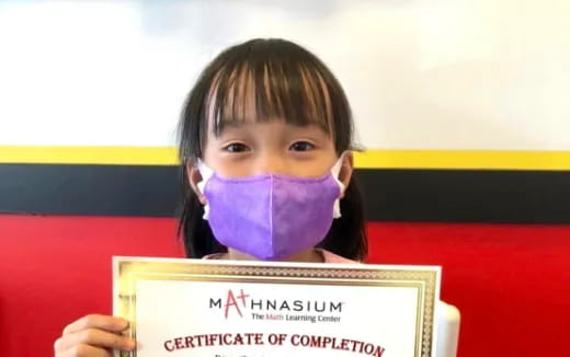 a girl holding a sign