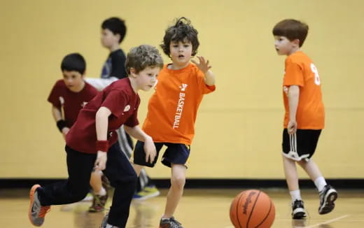 a group of kids playing basketball