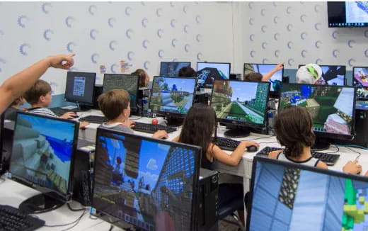 a group of people sitting at computers