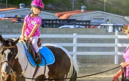 a girl riding a horse