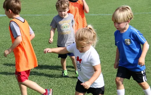 a group of kids playing football