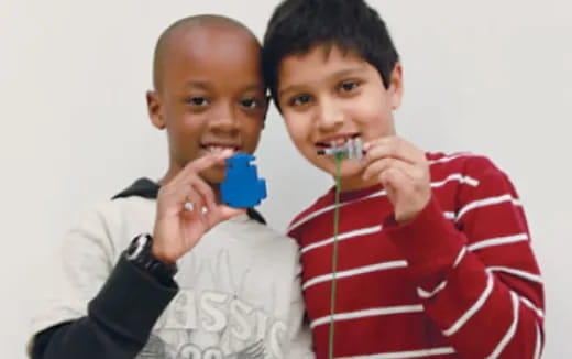 a couple of young boys brushing their teeth