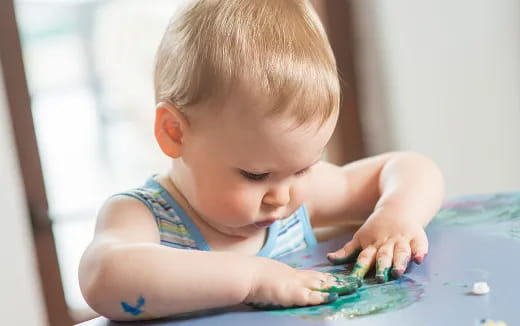 a baby playing with water