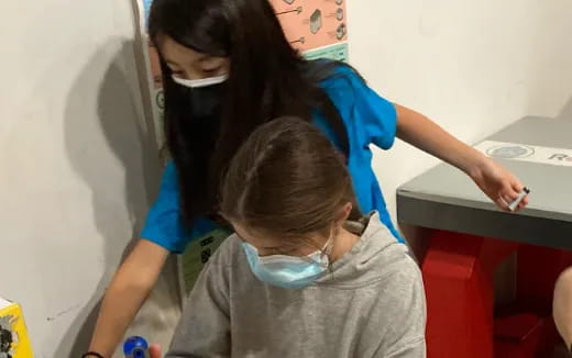 a person and a child wearing masks