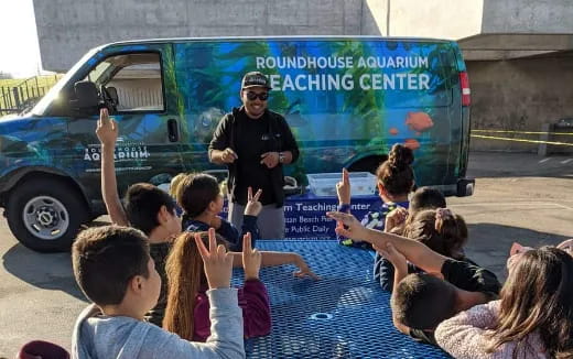 a person standing in front of a group of children
