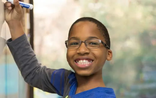 a boy holding a pen