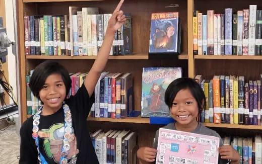 a couple of women holding books