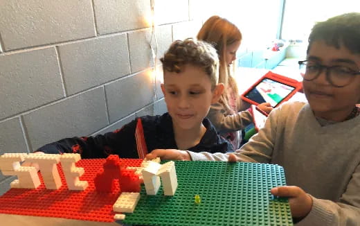 a group of kids playing a board game