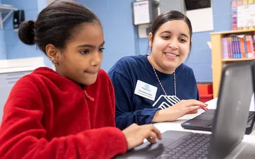 a few women working on a laptop
